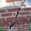 Lightning strike damage to brick casing of chimney. 