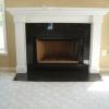 New prefabricated fireplace installed with new green marble and mantel.